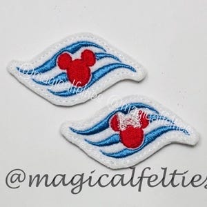 May include: Two white felt appliques with a blue wave design and a red Mickey Mouse head. One applique features a Minnie Mouse head with a white bow. The text "@magicalfelties" is at the bottom.