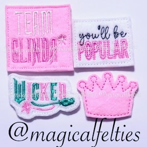 May include: Four felt patches with embroidered text and designs. The patches are pink, white, and green. The text on the patches reads "Team Glinda", "You'll be Popular", "Wicked", and a crown with the text "@magicalfelties".