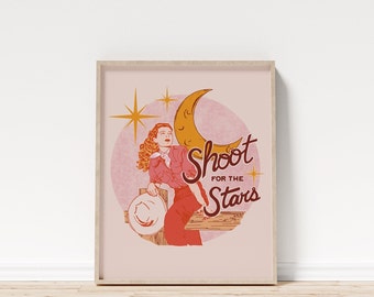 May include: A pink and yellow illustration of a woman sitting on a fence with a crescent moon and stars in the background. The text "Shoot for the Stars" is written in a retro font.
