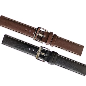 Puede incluir: Dos correas de reloj de cuero, una marrón y otra negra, con hebillas plateadas.