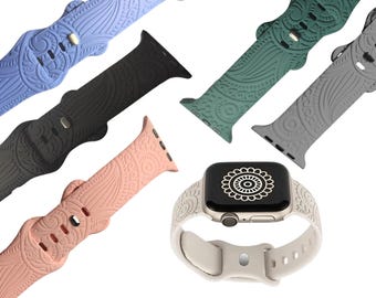 May include: Five different patterned Apple Watch bands. The bands are in black, blue, green, pink, and gray. The bands have a paisley design.