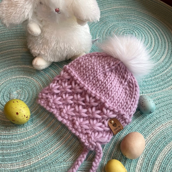 Baby girl bonnet style hat hand knit in soft merino wool.