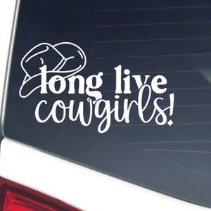 May include: White vinyl decal with the words "Long live cowgirls!" in a script font, with a cowboy hat graphic above the text. The decal is designed to be applied to a car window or similar surface.