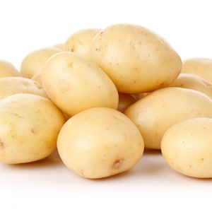 May include: A pile of yellow potatoes on a white background.