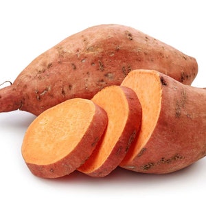 May include: A whole sweet potato and four slices of sweet potato. The sweet potato is a light brown color and the slices are a bright orange color.