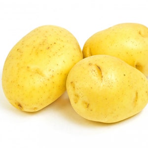 May include: Three yellow potatoes on a white background. The potatoes are smooth and have a slightly rough texture.