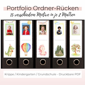 Puede incluir: Carpeta negra con etiquetas con fotos de niños e ilustraciones en acuarela. Las etiquetas incluyen un dinosaurio, un globo aerostático y un unicornio. El texto en la carpeta dice "Portfolio Ordner-Rücken" y "15 verschiedene Motive in je 2 Maßen."