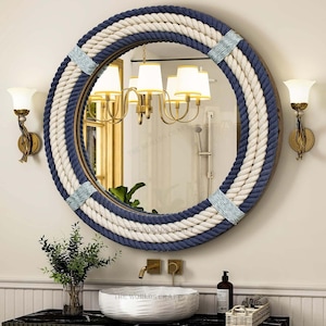 May include: A circular mirror with a nautical design, featuring a thick rope border in navy, white, and natural colours. The mirror has a wooden frame and light blue accents. The mirror is displayed in a bathroom setting.