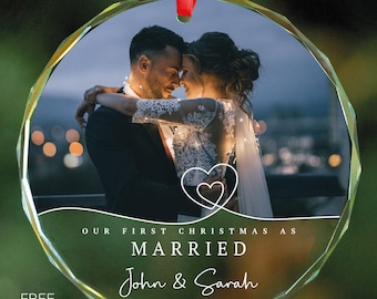 May include: A clear glass Christmas ornament with a photo of a couple embracing. The ornament has the text "Our First Christmas as Married John & Sarah 01.21.2024" printed on it.