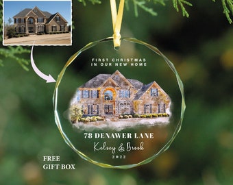 May include: A round, faceted glass ornament hanging from a yellow ribbon. It features a watercolor-style illustration of a two-story house with the text: FIRST CHRISTMAS IN OUR NEW HOME, 78 DENAWER LANE, Kelsey & Brook, and 2022.