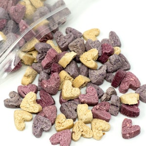 Tri-flavoured bite-sized treats for small animal flowing out of its clear packaging
