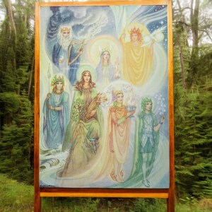 May include: A framed painting depicting seven figures in a forest setting. The figures are surrounded by a colorful, ethereal glow. The painting is set against a wooden background.