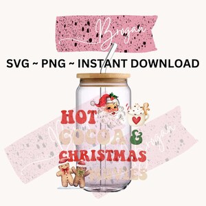 May include: A glass jar with a wooden lid and a straw, featuring a Christmas-themed design. The jar has a red and white Santa Claus face, gingerbread men, and the text "Hot Cocoa & Christmas Vibes".