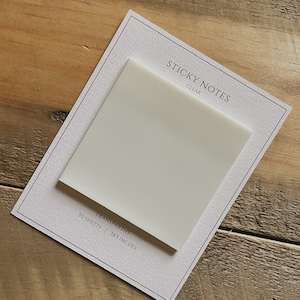 May include: A pack of clear sticky notes with the text "STICKY NOTES CLEAR" and "TRANSPARENT 50 SHEETS | 3X3 INCHES" printed on the front.