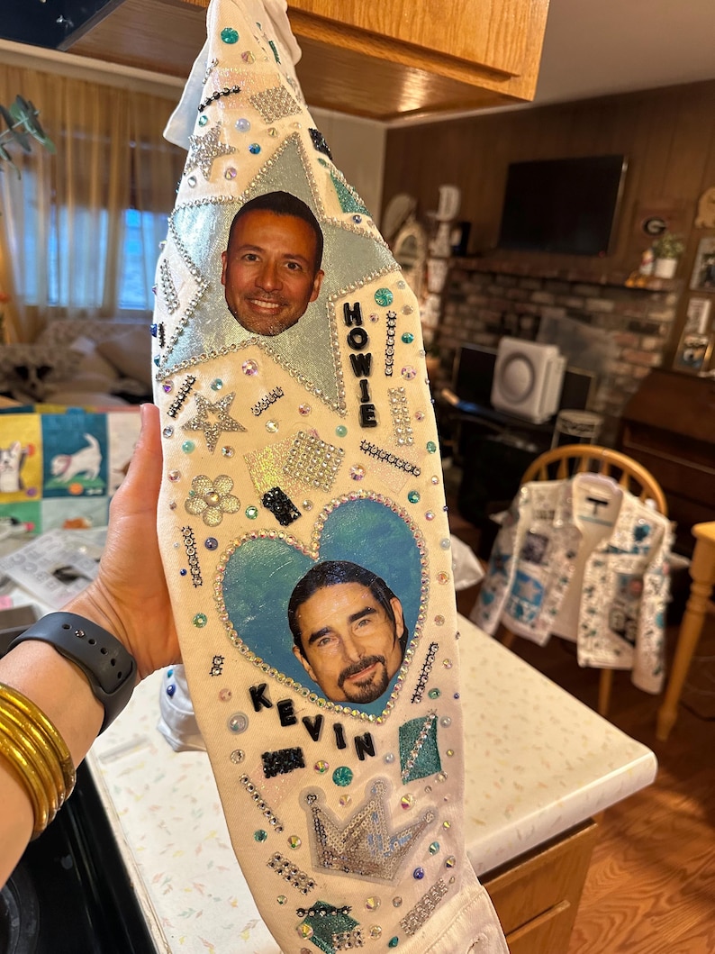 Embellished white fabric sleeve with rhinestones, glitter accents, and portrait patches.