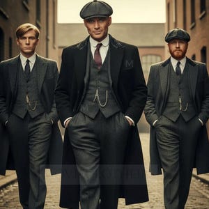 May include: Three men in vintage-style suits and flat caps walk down a brick-lined street. The suits are primarily gray with vests, pocket watches, and long black overcoats. The man in the center wears a dark cap and a white collared shirt with a burgundy tie.