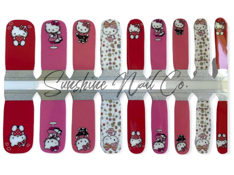 May include: A set of 10 Hello Kitty nail wraps featuring various designs, including Hello Kitty holding a heart, Hello Kitty in a dress, and Hello Kitty with a bow. The nail wraps are on a clear sheet with a silver glitter background and the text "Sunshine Nail Co."