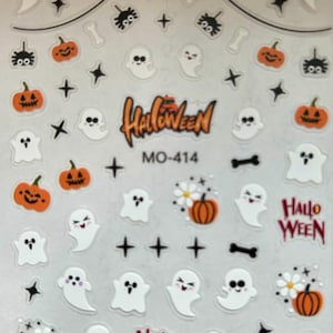 May include: A white ceramic mug with a black handle and the text "But First, Coffee" in a bold, black font. The mug is set against a blurred background, suggesting a cozy setting.