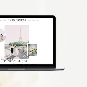May include: A laptop computer displaying a website with the text "LAURA GRAHAM" and the words "TIMELESS & ELEGANT IMAGES" in black text. The website features a photo of a couple walking in front of the Eiffel Tower in Paris, France.