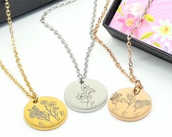 May include: Three delicate necklaces with engraved flower pendants. The necklaces are gold, silver, and rose gold. Each pendant features a different floral design.