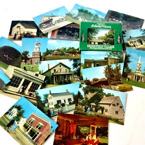 May include: A collection of vintage postcards featuring various buildings and scenes from Greenfield Village in Dearborn, Michigan, accompanied by a green cardboard box labeled Twenty Selected Views Greenfield Village Dearborn Michigan.