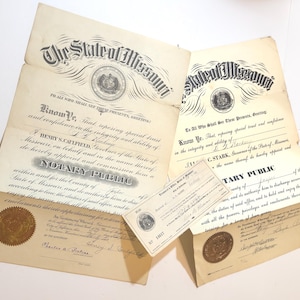 May include: A collection of antique documents from The State of Missouri, including notary public certificates and official seals. The documents feature ornate calligraphy and are aged with a vintage aesthetic.