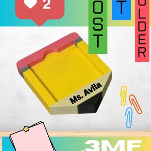 May include: A yellow, pencil-shaped sticky note holder with a pink eraser top, a grey metal band, and a black tip. The holder features the text Ms. Avila printed in black on the side. Three colorful paper clips are positioned to the right.