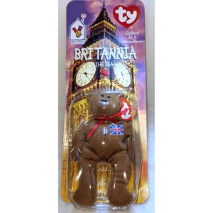 May include: Brown Beanie Baby bear named Britannia, wearing a red ribbon and a Union Jack flag patch. The packaging features a picture of Big Ben and the text "Collect All 4!"