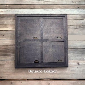 May include: A dark brown wooden square frame divided into four equal quadrants by a central crossbar. Each quadrant features a small semi-circular cutout along the inner edge. The text Square Leaner is printed in white below the frame.