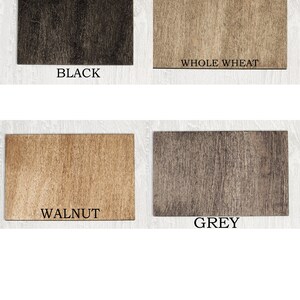 May include: Four rectangular wooden samples in black, whole wheat, walnut, and grey. Each sample has a wood grain texture and a label with the color name in white text.