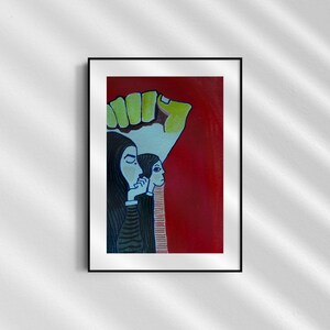 May include: A framed painting of two women with dark hair, wearing headscarves, standing in front of a large, green and yellow fist. The background is red.