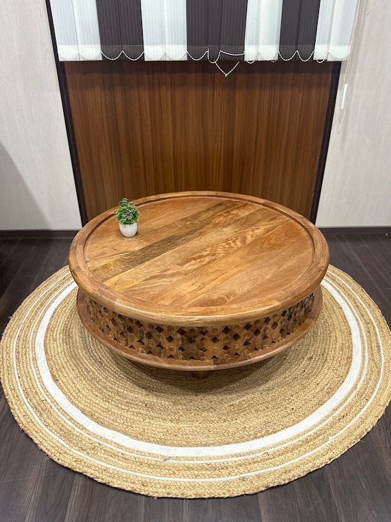 Round carved coffee table discount