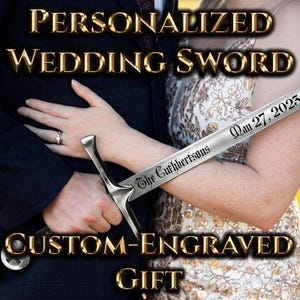 May include: A silver-toned metal sword featuring a custom engraving on the blade that reads The Cuthbertsons and May 27, 2023. The sword has a metallic crossguard and a pommel, with the text clearly visible along the length of the steel blade.