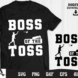 May include: A black t-shirt with white text that reads "Boss of the Toss". The design features a silhouette of a person throwing a frisbee.