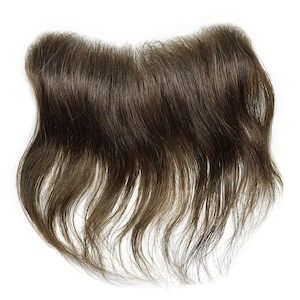 May include: A brown hairpiece for men, designed to cover a receding hairline or bald spot. The hairpiece is made of human hair and has a natural, wavy texture.