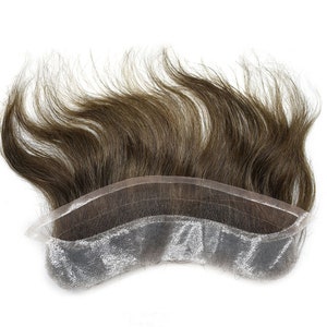 May include: A brown human hair toupee with a lace front. The lace is a light gray color and the hair is long and wavy.