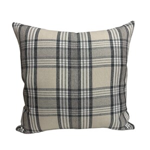 May include: A beige and gray plaid throw pillow with a square shape.