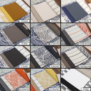 May include: A fabric swatch sample book featuring twelve distinct color and pattern options labeled 49 through 60, including solid colors like caramel, off-white, slate blue, mocha, graphite, and white, alongside palm leaf prints and striped patterns.