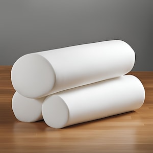 May include: Three white cylindrical foam rollers stacked on top of each other on a wooden surface.