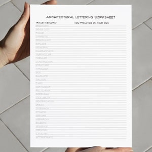 Image of someone holding the Architectural Lettering Worksheet in their hands in front of a white wall.