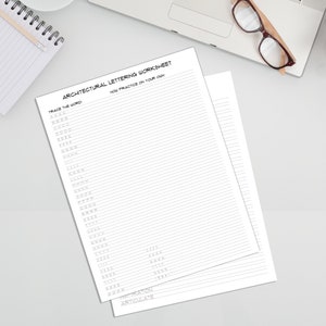 2 pages from the Architectural Lettering Worksheet page on a blank counterspace.