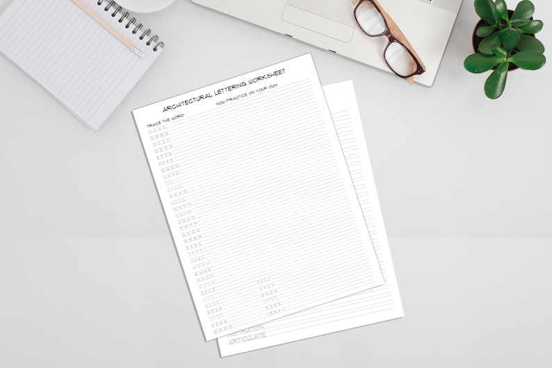 2 pages from the Architectural Lettering Worksheet page on a blank counterspace.