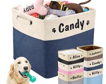 May include: A set of six canvas storage bins with personalized names, including "Candy", "Alice", "Jaskson", "Killy", and "Bella". The bins are beige and blue with black lettering. A golden retriever dog is holding a green chew toy in its mouth.