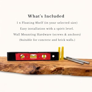 May include: A live-edge wooden floating shelf with a black and red spirit level, two yellow plastic wall anchors, and two metal mounting screws. The text reads: What's Included, 1 x Floating Shelf, Easy installation with a spirit level.