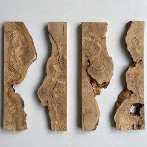 May include: Four rectangular wooden planks with irregular edges. The planks are a light brown colour with darker brown grain patterns and knots. The wood has a natural, rustic appearance, with some planks showing cracks and holes.
