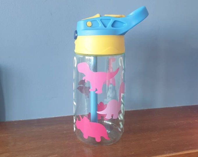 Dinosaurs Kids 480ml pop up spout water bottle with handle personalised with a vinyl name and colourful dinosaurs design.BPA free.