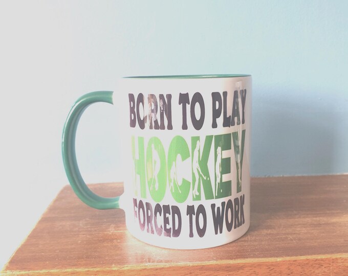 Hockey mug with humourous theme and the wording 'Born to play Hockey, Forced to work'