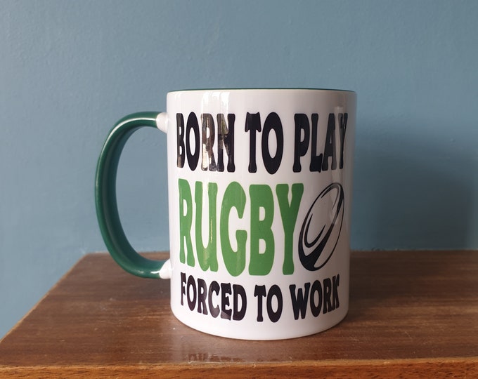 Rugby mug with humourous theme and the wording 'Born to Play Rugby, Forced to work'