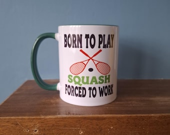 Squash mug with humourous theme and the wording 'Born to Play Squash, Forced to work'
