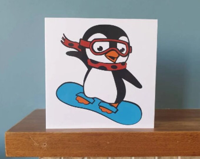 A handmade cut out design snowboarding penguin Birthday / greetings card.
